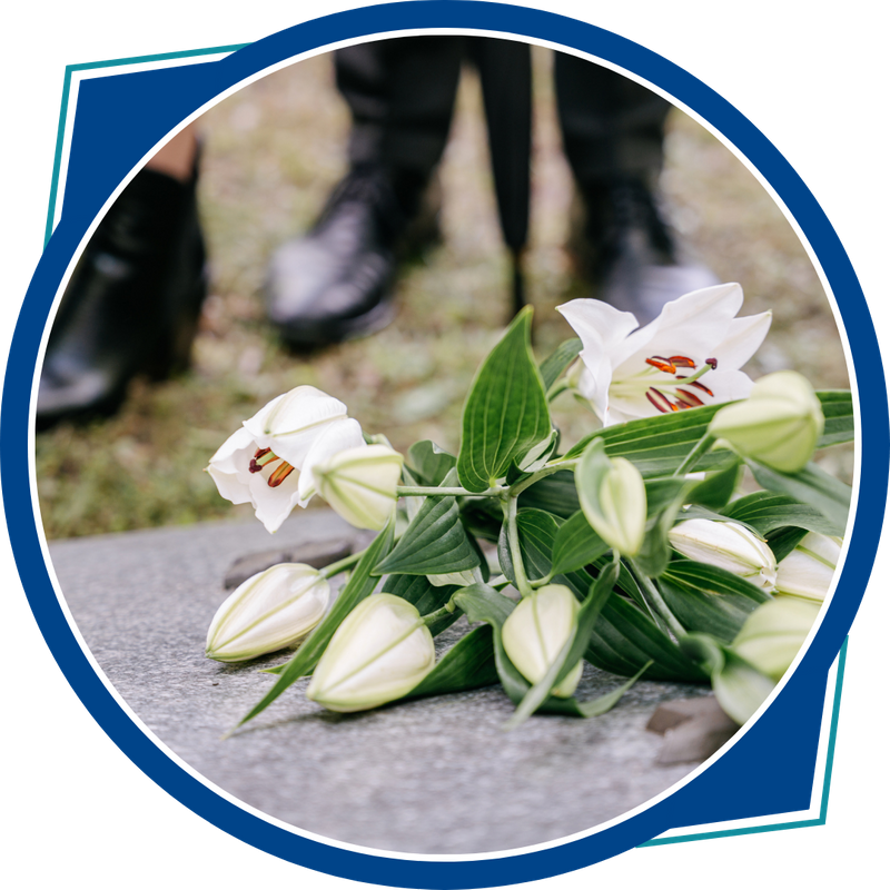 lilies on grave during funeral